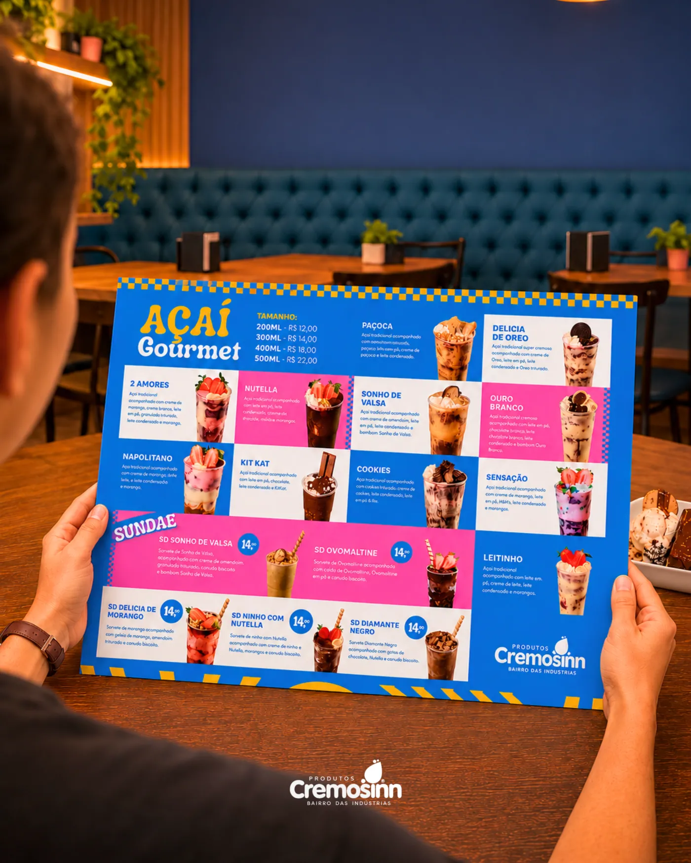 Cliente segurando o cardápio de CREMOSINN, sorveteria - açaiteria